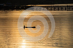 Silhouette fisherman and wood bridge, Sangkhlaburi