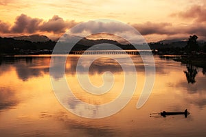 Silhouette fisherman with wood bridge at Sangkhlaburi