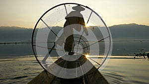 Silhouette fishermen in Inle Lake at sunrise, Myanmar