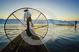 Silhouette fishermen in Inle Lake at sunrise, Shan State, Myanmar