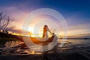 Silhouette of fishermen using nets to catch fish at the lake