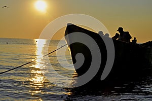 Silhouette of fishermen working in the sunset