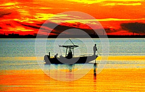 The silhouette of a fishing boat by the bay during sunset near Clearwater, Florida, U.S