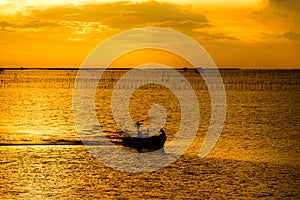 Silhouette of fishing boat and fishermen in sea