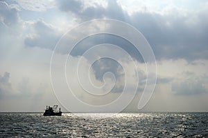 Silhouette of a fishing boat offshore