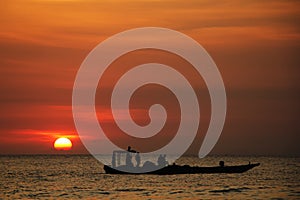 Silhouette of fishing boat return to port