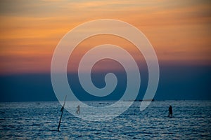 Silhouette of fishing boats against sunset