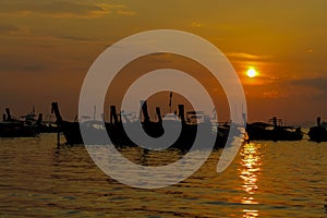 Silhouette of fishing boats sunset on sea beach resort in Thailand, Krabi, Railey and Tonsai