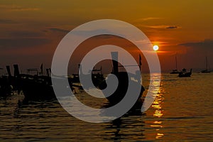 Silhouette of fishing boats sunset on sea beach resort in Thailand, Krabi, Railey and Tonsai