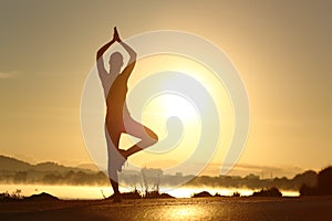 Silhouette of a fitness woman exercising yoga meditation exercise