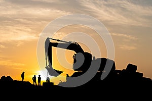Silhouette of Foreman and workers team at construction site, Road construction worker and excavator with blurred sunset background