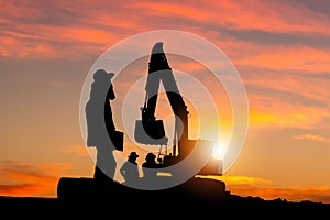 Silhouette of Foreman and workers team at construction site, Road construction worker and excavator with blurred sunset background