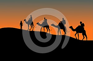 Silhouette of four camel riders. Up hill with sunset background