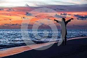 Silhouette of free woman enjoying freedom feeling happy at beach