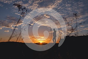 Silhouette of free woman enjoying freedom feeling happy at sunset. Serene relaxing woman in pure happiness