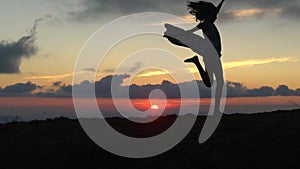 Silhouette of free woman run at sunset, enjoying freedom feeling happy. Woman in pure happiness. Silhouette of woman