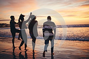 Silhouette, friends and at the beach or sea relax, happy and have fun with sunset view on vacation together. Group, men