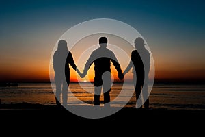 Silhouette of friends on beach