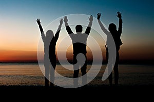 Silhouette of friends on beach