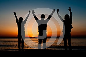 Silhouette of friends on beach