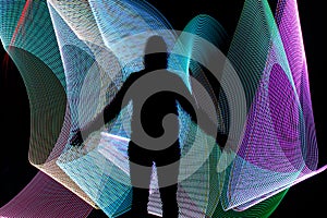 Silhouette in front of abstract freezelight background
