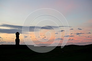 Silhouette of a giant statue of Easter Island at sunset. The moai of Ahu Ko Te Riku, Hanga Roa, Easter Island, Chile photo