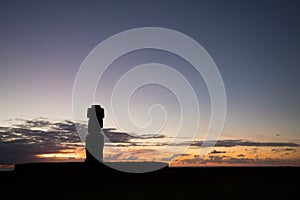 Silhouette of a giant statue of Easter Island at sunset. The moai of Ahu Ko Te Riku, Hanga Roa, Easter Island, Chile photo