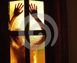 Silhouette of a girl behind a glass door