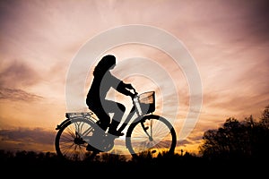 Silhouette of the girl on bicycle