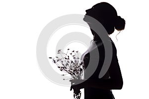 Silhouette of a girl with a bouquet of dry dandelions looking up, the face profile of a young woman on a white isolated background