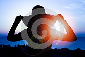 Silhouette of a girl on a chair on a nature background