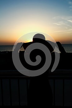 Silhouette of a girl on a chair on a nature background