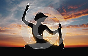 Silhouette of girl doing yoga over sunset