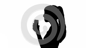 Silhouette of a girl drinking from a can. black and white mask