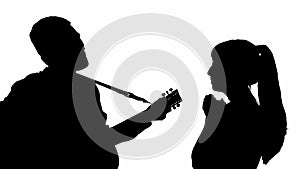 Silhouette of a girl with a guy playing the guitar. black and white mask
