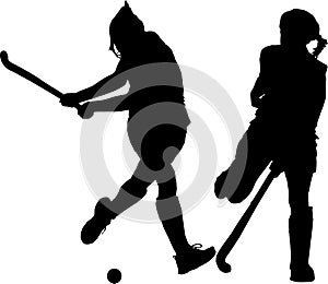 Silhouette of girl hockey players hitting