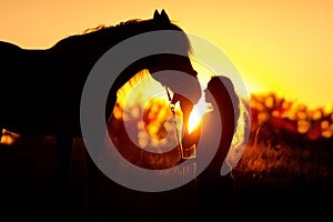 Silhouette of girl and horse