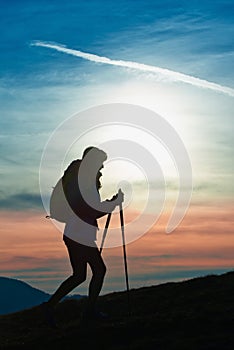 Silhouette of a girl on a mountain during a religious trek