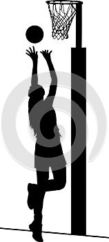 Silhouette of girl netball player shooting for goal