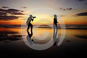 Silhouette of Girl And Photographer during sunset