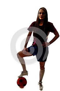 Silhouette of girl playing football