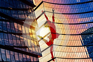 Silhouette of a girl, in the pose of a jumping ballerina on the facade of a skyscraper, with outstretched arms in the form of