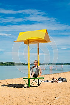 Empty beach with a bench with a canopy on the coast