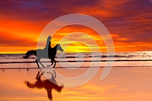 Silhouette of the girl skipping on a horse