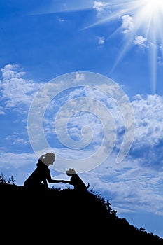 Silhouette of girl train a dog