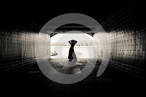 Silhouette of a girl in a tunnel