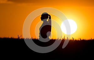 Silhouette of girl in wheat field