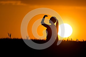 Silhouette of girl in wheat field