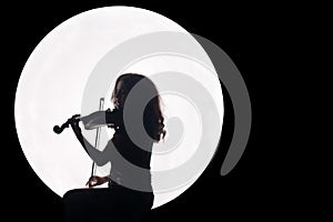 Silhouette of a girl in a white circle with a violin in her hands. Concept. Music for the full moon. Night background