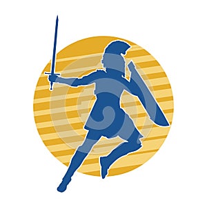 Silhouette of a gladiator or a warrior in action with armor and sword blade weapon.